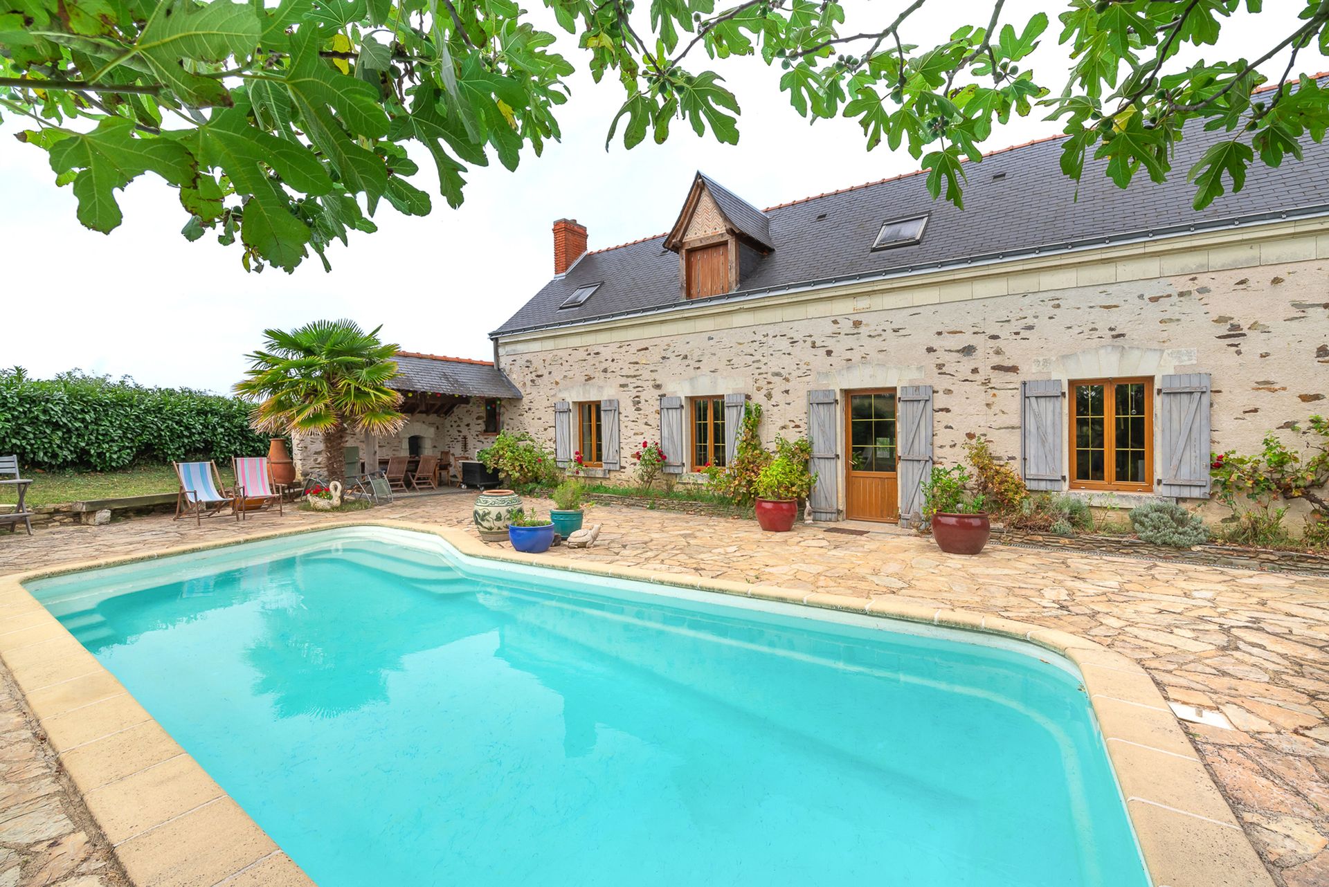 Rustic French country house featuring a serene swimming pool in Angers, France.